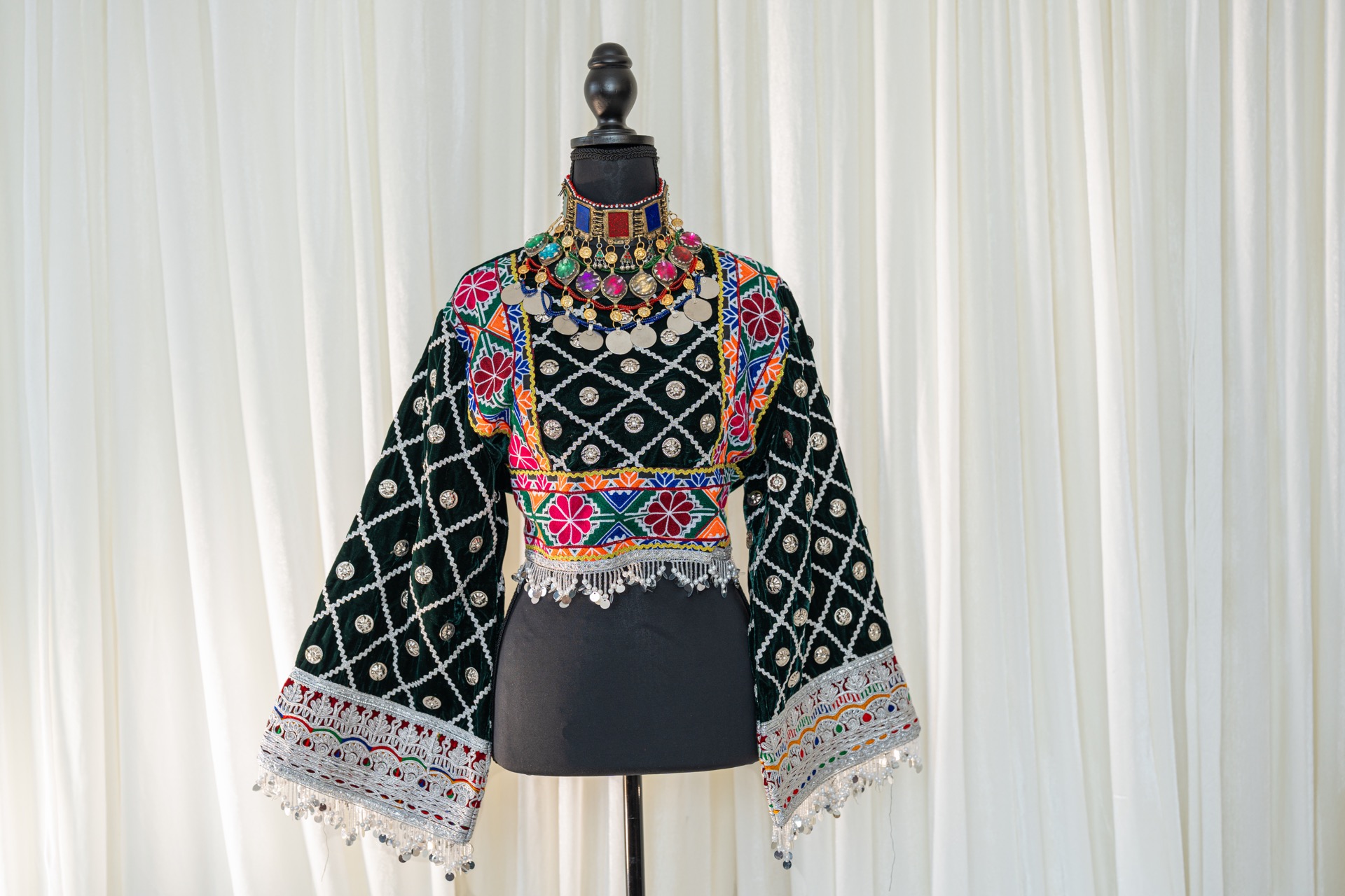 A woman wearing a traditional afghan dress.