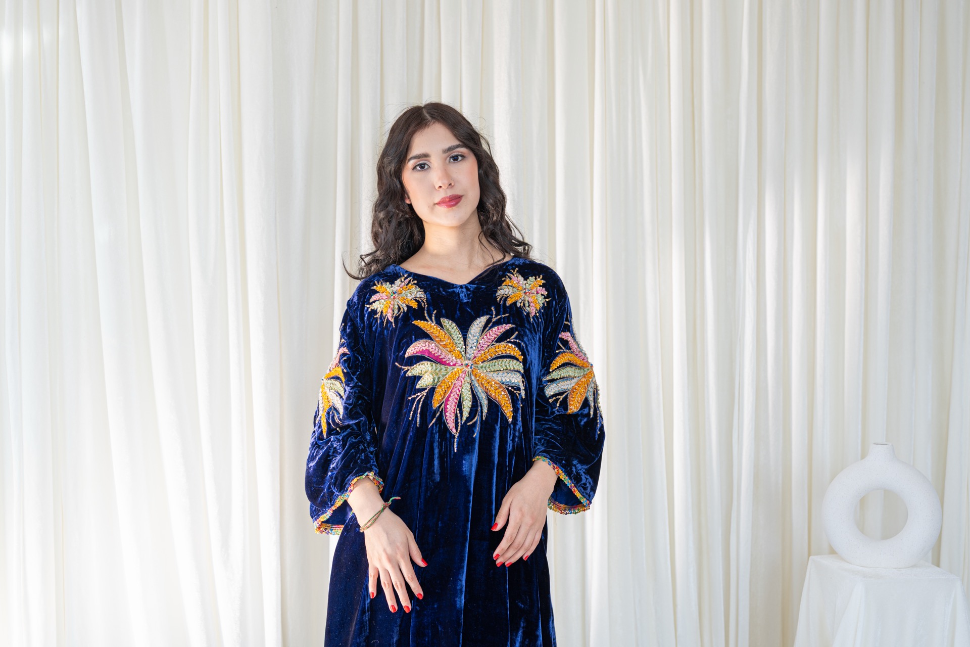 A woman wearing a traditional afghan dress.