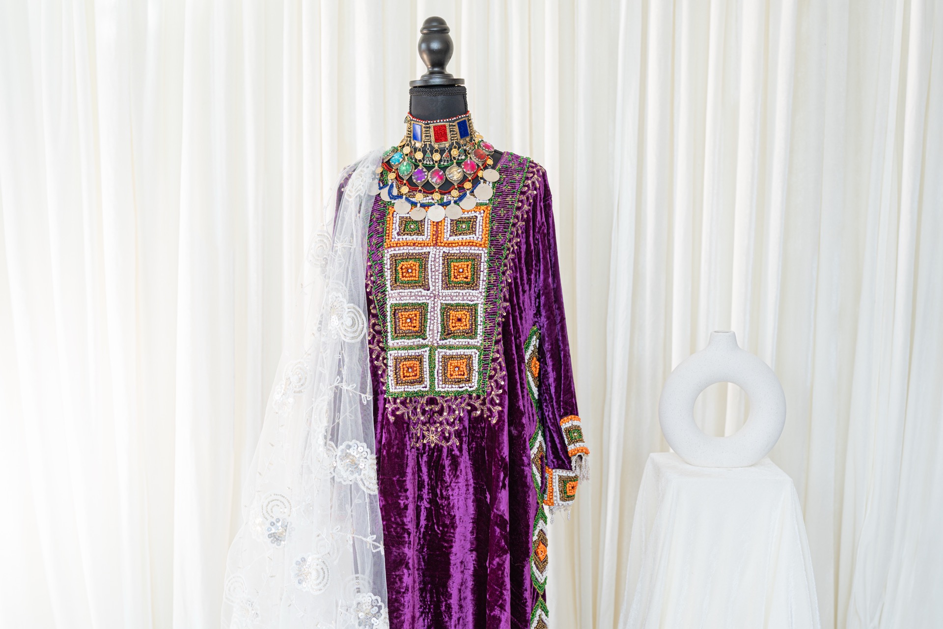 A woman wearing a traditional afghan dress.